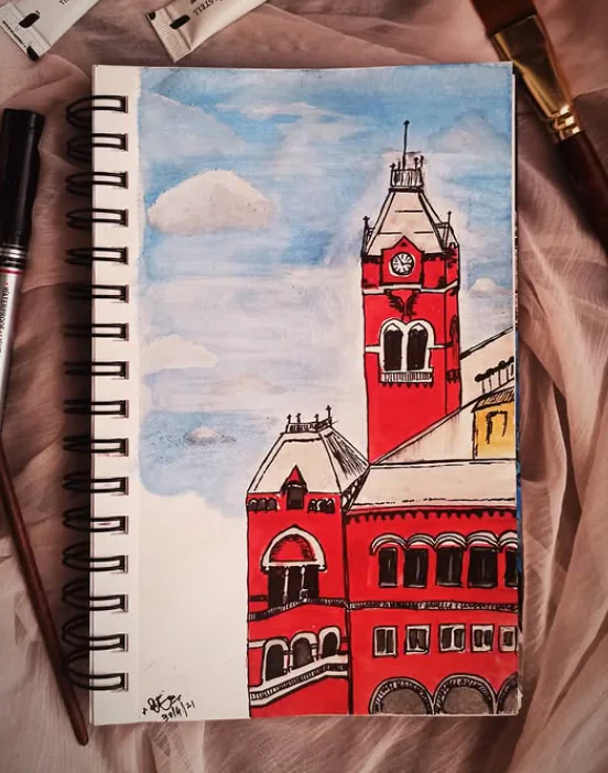 Watercolour sketch of a red clock-tower building in a spiral sketchbook