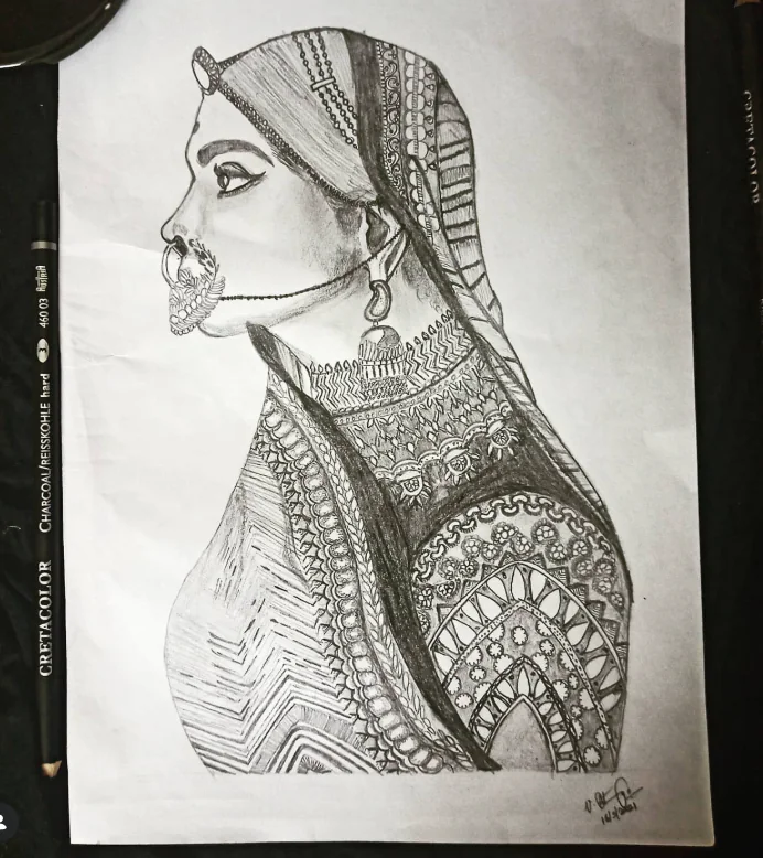 Pencil sketch of a woman in profile wearing a nose ring and an intricately patterned saree